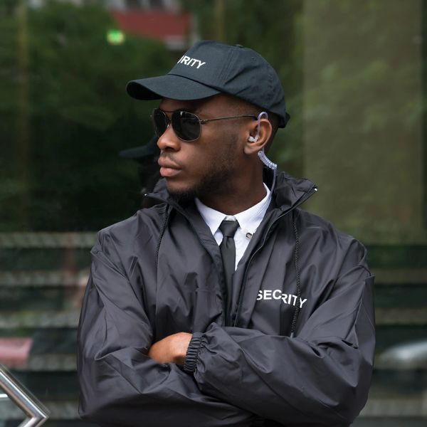 Security guard with headphone and black shades