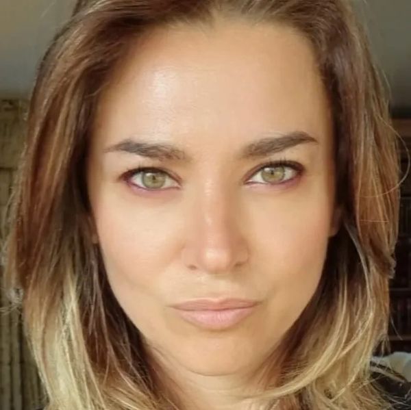 Close-up of a woman with green eyes and light brown hair.