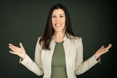 Smiling woman with open arms.