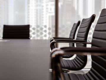 High-specification conference table and ergonomic leather chairs with stainless steel arm rests