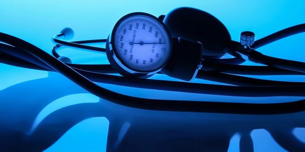 a blood pressure cuff lying on an illuminated blue surface