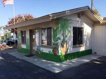 Potted tropical plants painted on outside wall of office in Hemet, CA