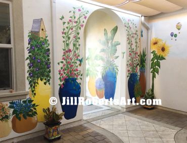 Exterior courtyard wall murals of potted plants, sunflowers, large leaves. Temecula, CA