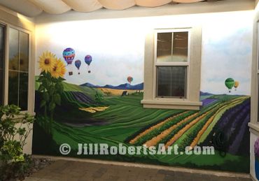 outdoor courtyard painted wall mural of temecula winery vineyards, sunflowers, hot air balloons