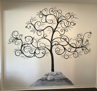 Swirly decorative tree mural painted on a cream wall. grey and black. 10' tall. Murrieta CA