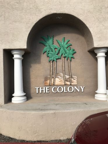 Painted wall mural of palm trees and sand at The Colony Murrieta, CA. 3D mural mounted on wall.