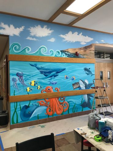 Underwater mural with orange octopus, whale, stingray, dolphin painted by jill Roberts Menifee, CA