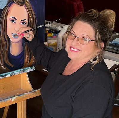 Jill Roberts sitting and painting a portrait in Anza, California.