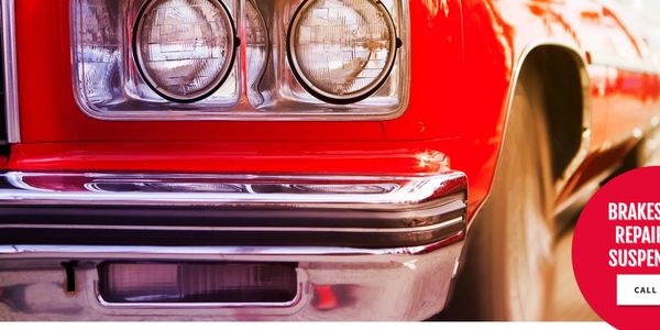 Red classic car with square headlights, bumper
