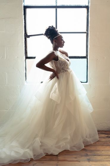 A stunning bride standing in front of a window before the ceremony at the Ambient + Studio in ATL  