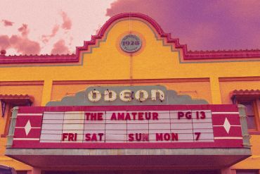 Vintage Odeon theater marquee displaying movie details for The Amateur.