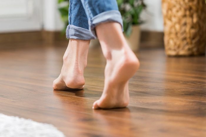 woman walking on quality oak hardwood floor refinishing near me, Cleveland OH affordable flooring