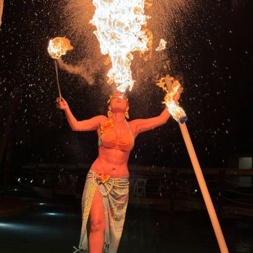 Bellydancer blowing fire out of her mouth like a dragon.