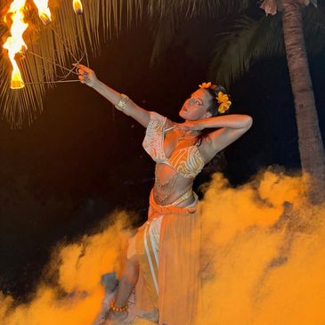 Polynesian dancer holding fire.