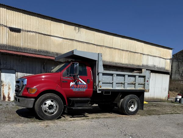 Pioneer Dirt Works dump truck parked outside the company lot.