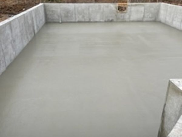 Poured concrete walls on top of a concrete foundation for stability and structure.