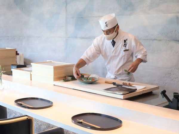 Chef preparing omakase sushi with care at Ganko Sushi Singapore