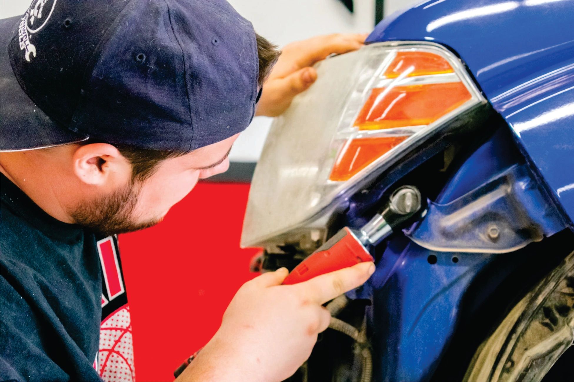 Stack of books next to pencils in a holder and a camera.