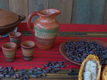 Our table with the cacao pod open and the seeds spread around a tradicional ceramics 
