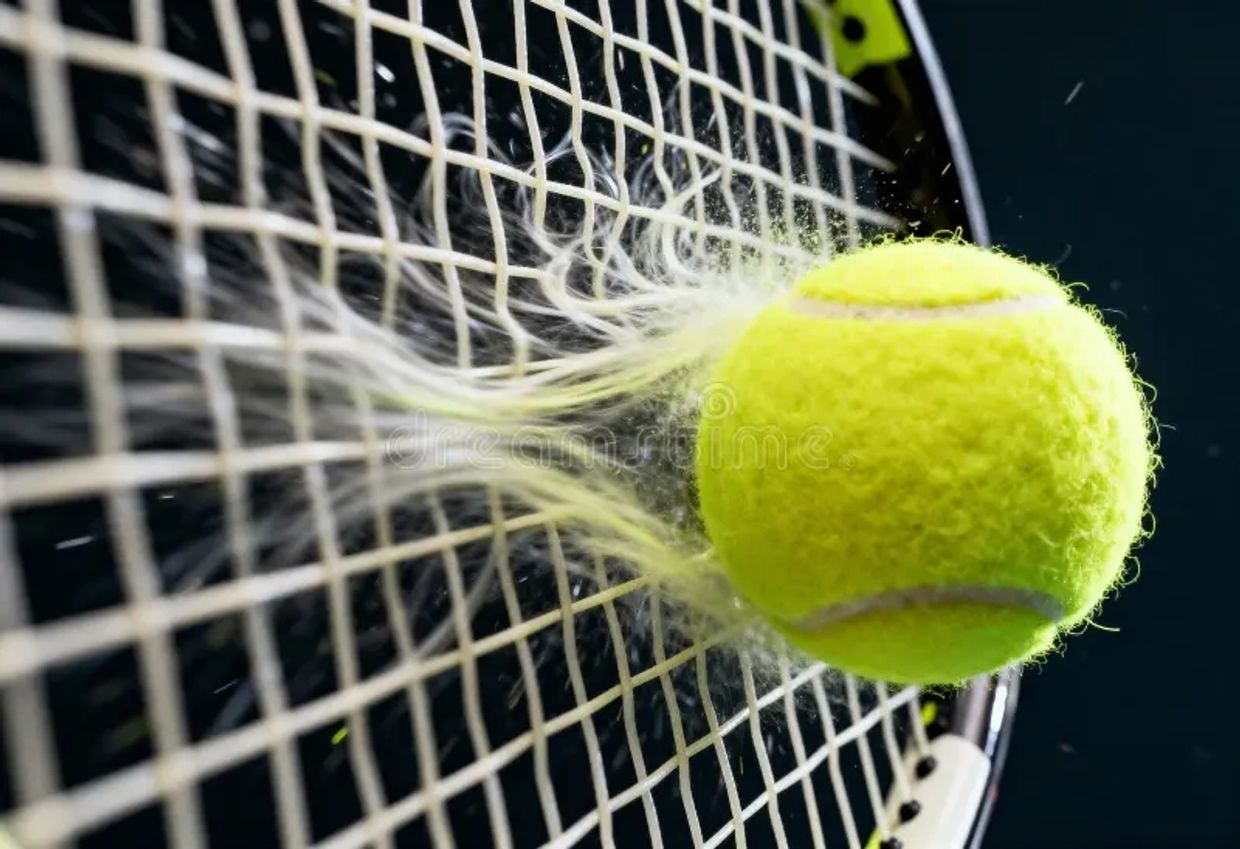 Tennis ball hitting a racket with force.