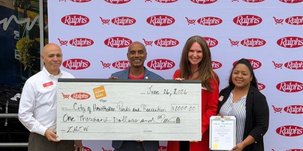 Four people holding a large $1000 donation check from Ralphs.