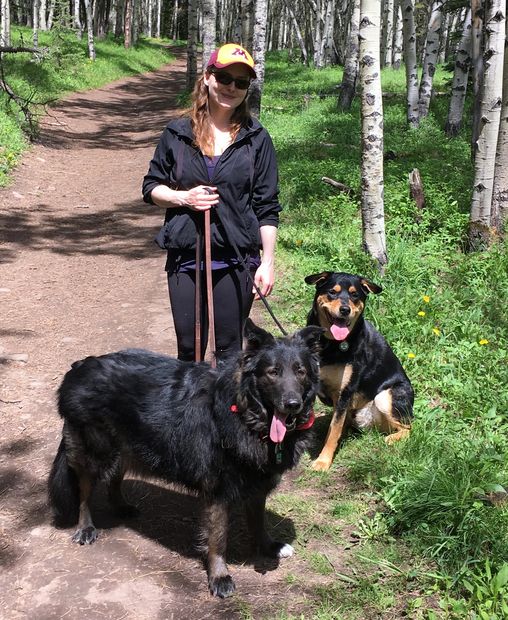 A picture of Ariane and her two dogs on a hiking trail - taken on holiday.  