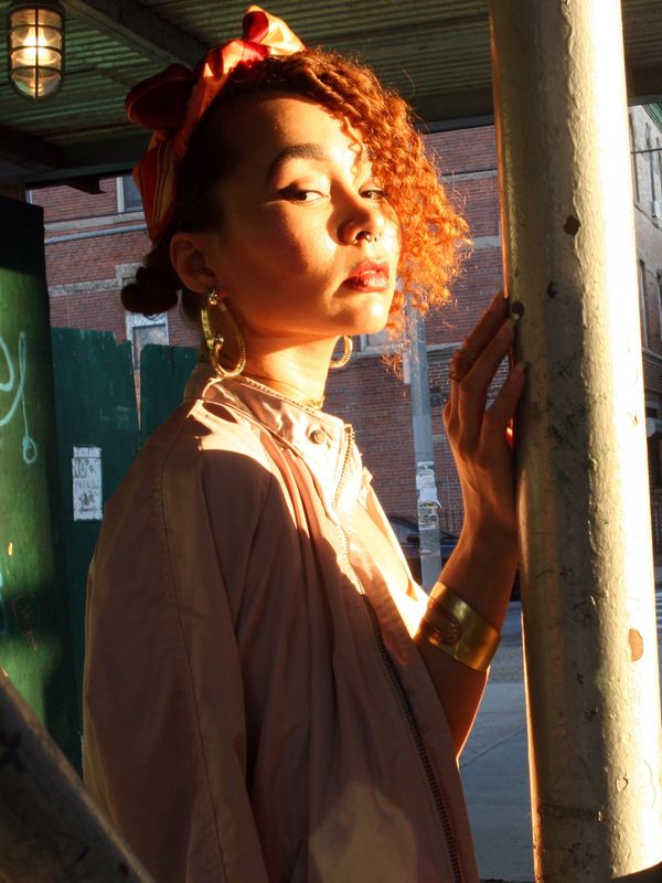 Designer Christina Grace Maldonado in golden light—fashion creative, storytelling, and design ethos.