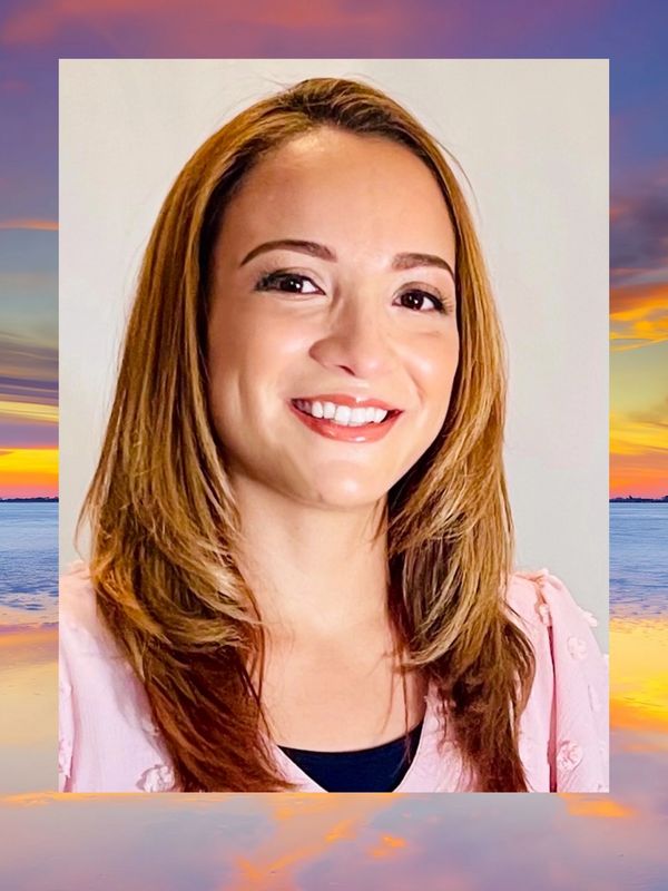 Smiling woman with shoulder-length hair.