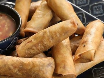 Golden fried spring rolls served with dipping sauce.