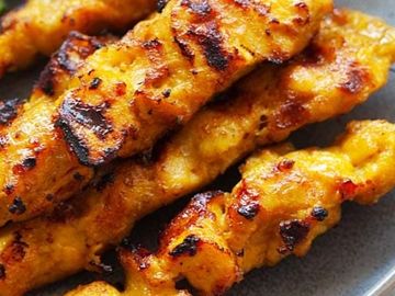 Grilled chicken skewers with a golden, charred finish.