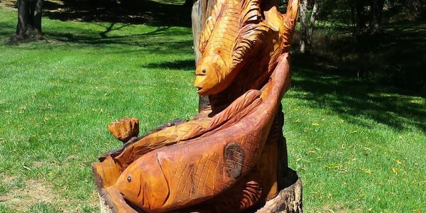 Chainsaw-carved fish from an old tree