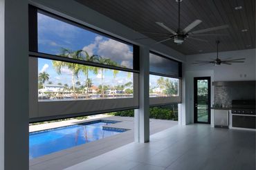 Covered patio overlooking pool and waterfront.