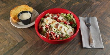 Chopped wedge salad with iceberg lettuce, bacon, tomatoes, blue cheese, and house-made balsamic vina