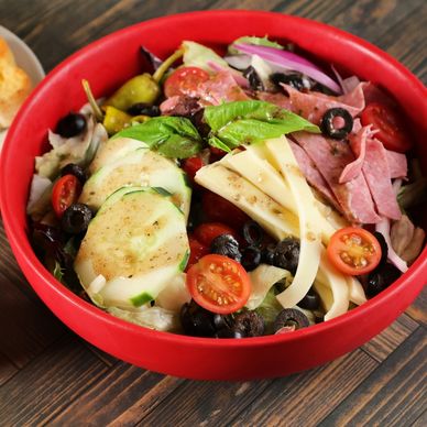 Dominic Antipasto Salad with salami, provolone cheese, tomatoes, cucumbers, red onion, black olives,