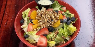 Strawberry pecan salad with grilled chicken, blueberries, mandarin oranges, feta cheese, and candied