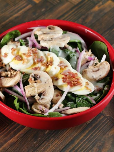 Fresh Spinach Salad with mushrooms, red onion, hard-boiled egg, and warm bacon dressing at D'Agostin