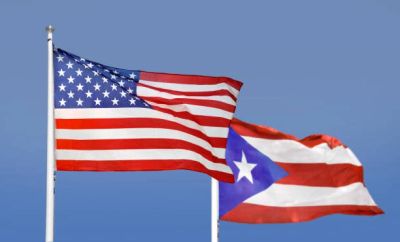American and Puerto Rican flags waving together.