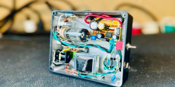 Open electronic device with visible wiring and components.