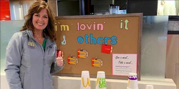 Susan Mann with a board in her Jasper Indiana restaurant. 