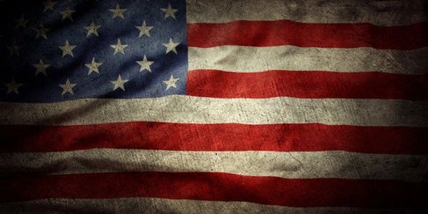 A weathered American flag with 26 stars and red and white stripes.