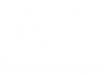 White stylized signature text on a black background.