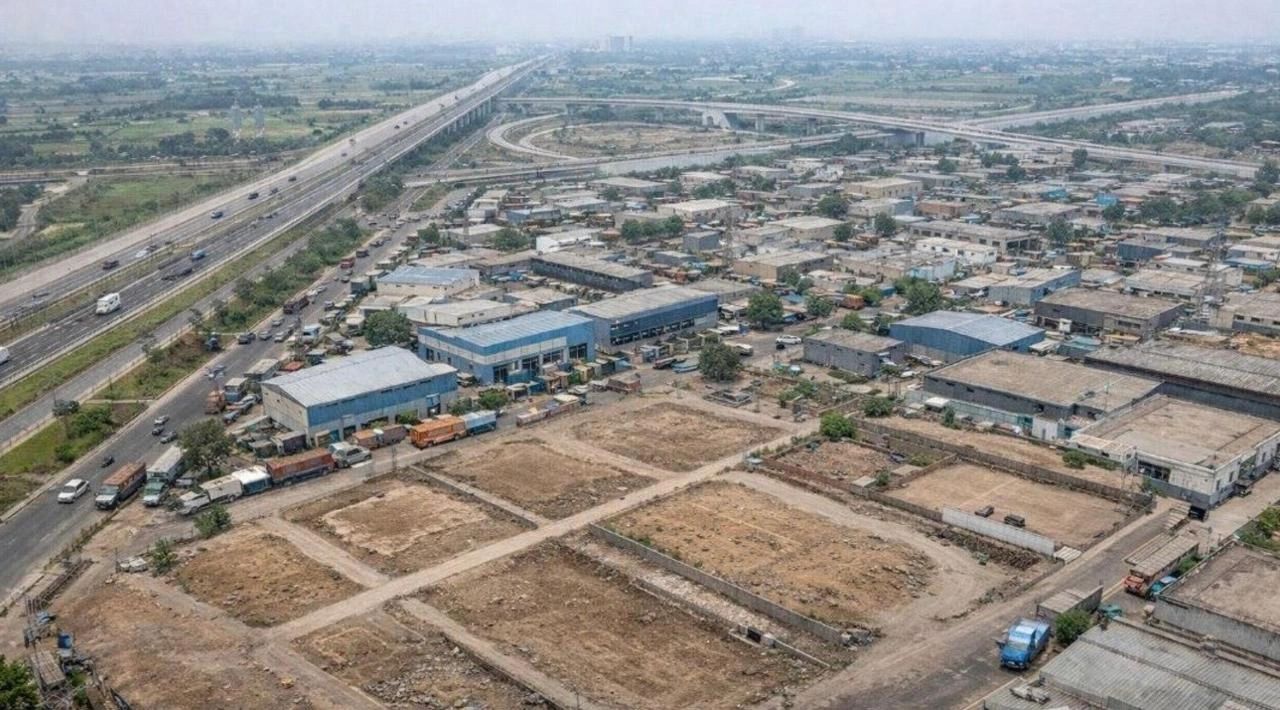 Aerial view of industrial buildings and highways.