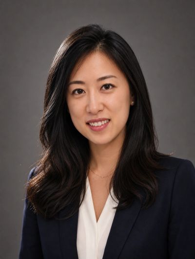 Professional portrait of a woman in business attire with a warm smile.