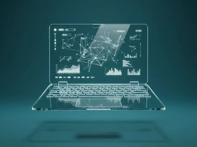 Transparent laptop with digital data visualizations floating above keyboard.