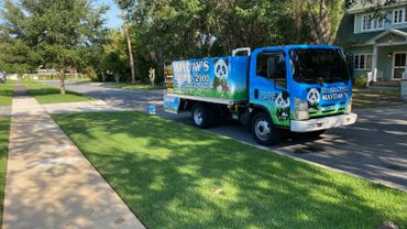 Bright blue Mayday's pest control truck parked on a suburban street.