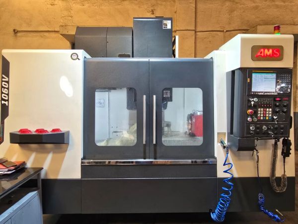 Industrial CNC machine with dual glass doors and control panel.