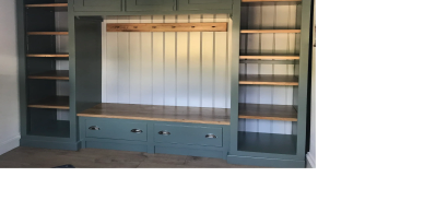 Wooden built-in shelving unit with seating.