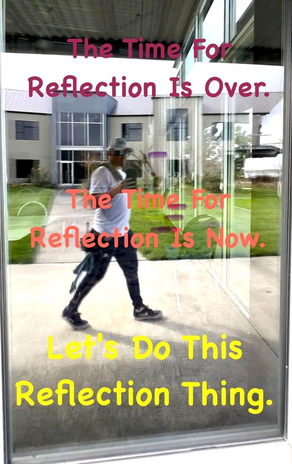 Man's reflection on glass with motivational text about reflection and action.