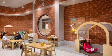 Children engaged in activities in a warm, brick-walled classroom.