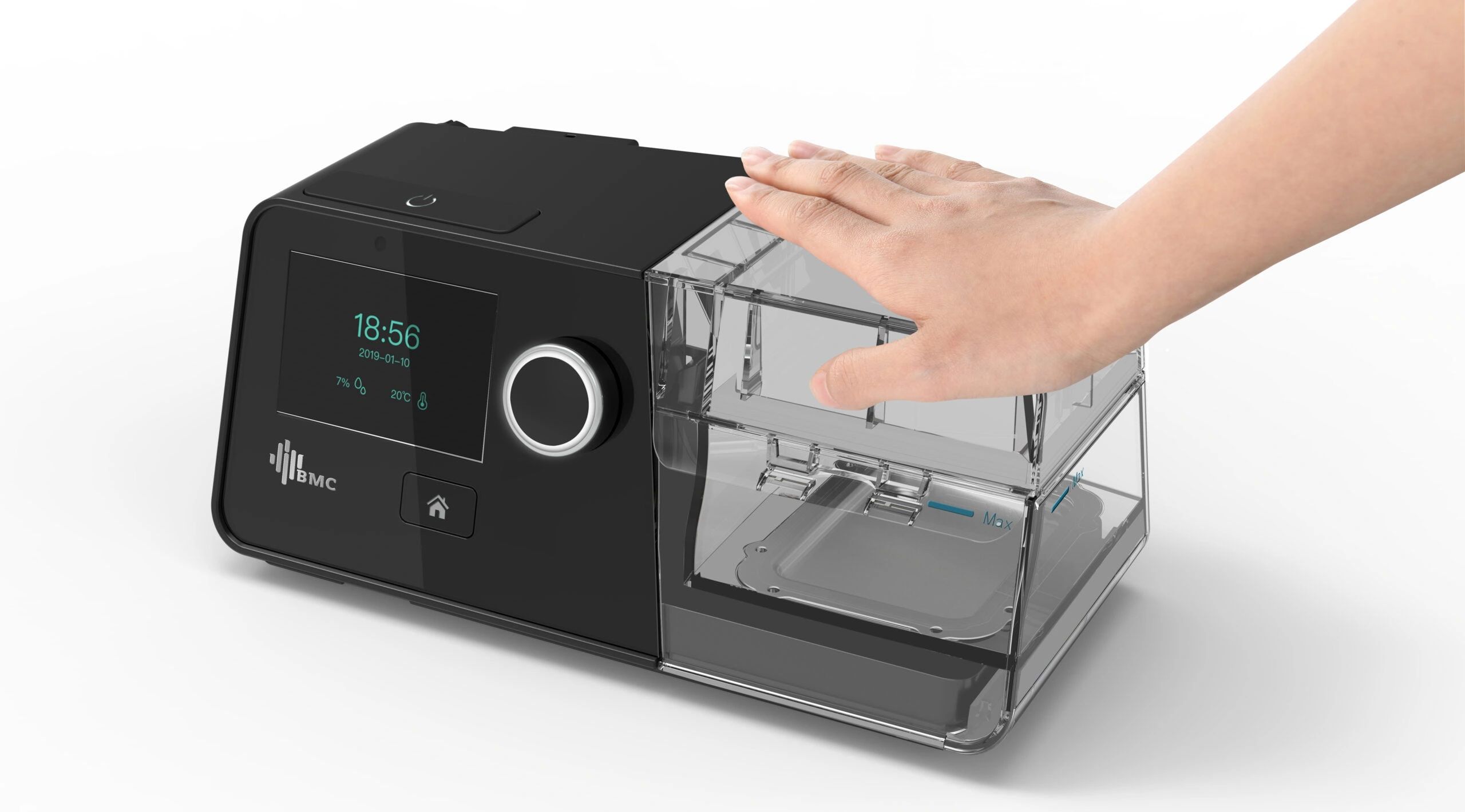 Hand operating a modern CPAP machine with digital display and water chamber.